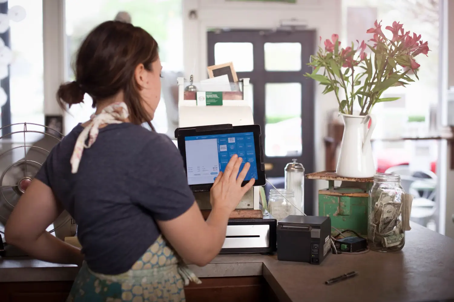 Bakery owner using cash register