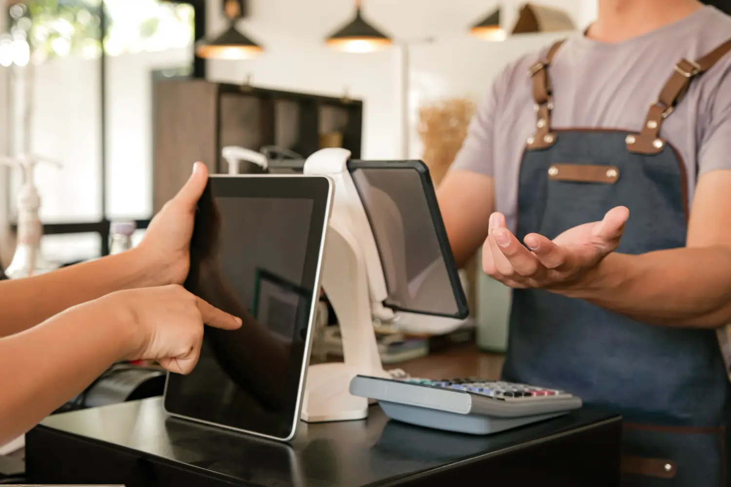 Barista using POS screen to receive orders